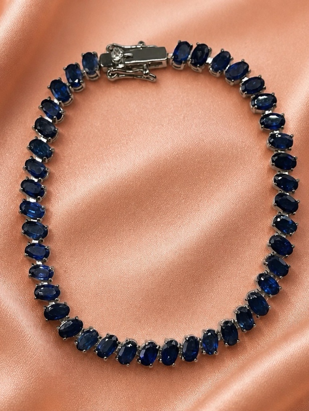 Blue Sapphire Tennis Bracelet set in rhodium over 925 Sterling Silver. 7”. NEW!